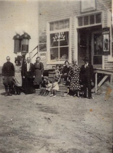 Jacynthe Gilbert — magasin — Tags: magasin, famille — Arthur Gilbert et Hélène Fillion ont commencé leur commerce au coin dans une petite maison sur la ferme de E. [Lemieux?]. C\'est Arthur qui a construit le magasin actuel, sur le terrain acheté en [19--] par sa conjointe Hélène Fillion. Armand Gilbert et Hélène Larouche, Adélard Gilbert et Louisa Harvey, Aline, Jacqueline et Madeleine Gilbert, les 5 filles d\'Arthur Gilbert et Hélène Fillion, propriétaire du magasin, marche du bas, Yvon, Denyse et Solange Gilbert, enfants d\'Armand et Hélène